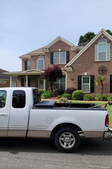 Photo of Lawn Hero truck parked in front of a customers yard